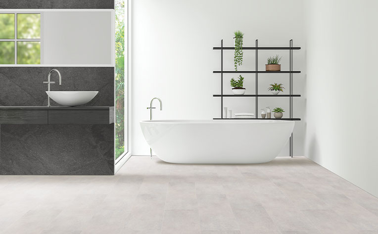 luxury vinyl tile flooring in bathroom with bathtub and plants